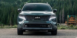 Front view of a dark green 2022 Kia Sorento with the headlights on. | Kia dealer in Sherwood, AR.