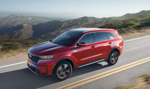 A red 2022 Kia Sorento Hybrid being driven on the road. | Kia dealer in Sherwood, AR.