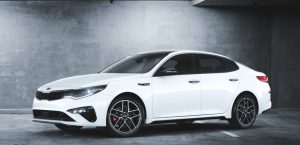 A white 2020 Kia Optima parked in a garage. | Kia dealer in Sherwood, AR.