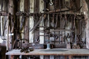 Blacksmith shop with tools on the table and the wall. | Historical attractions around Sherwood, AR.