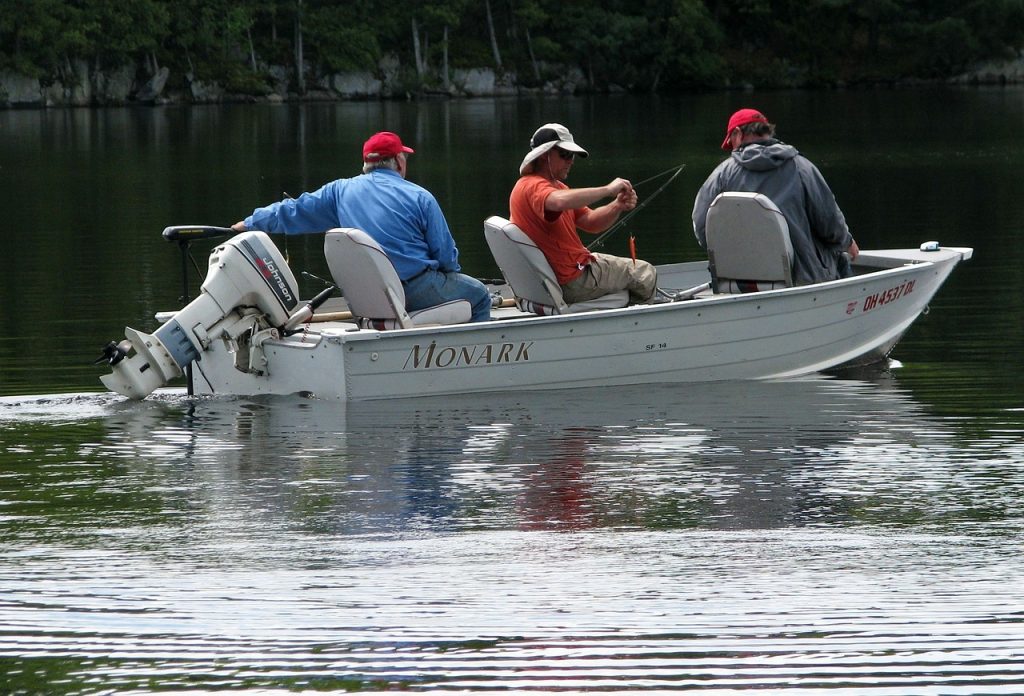Three fishermen on a boat on a lake fishing. | Spring activities near Little Rock, AR | Crain Kia of Sherwood