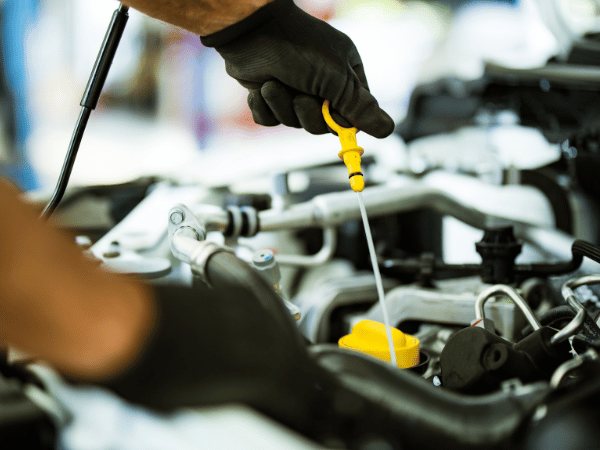 Service professional changing oil at Crain Kia of Sherwood